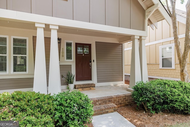 entrance to property featuring covered porch and board and batten siding