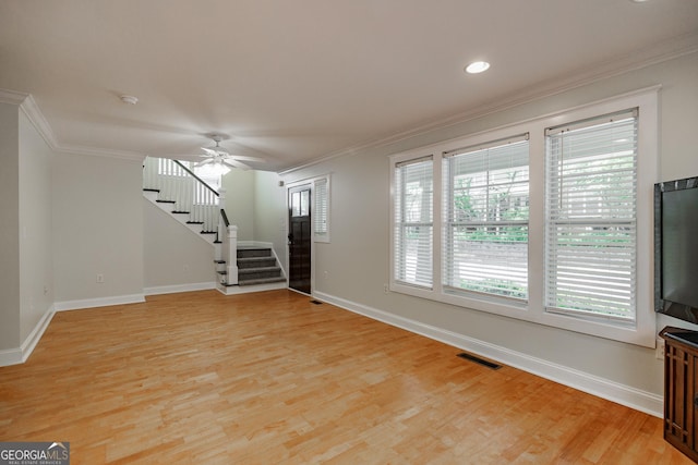 unfurnished living room with light wood-style floors, baseboards, stairs, and visible vents