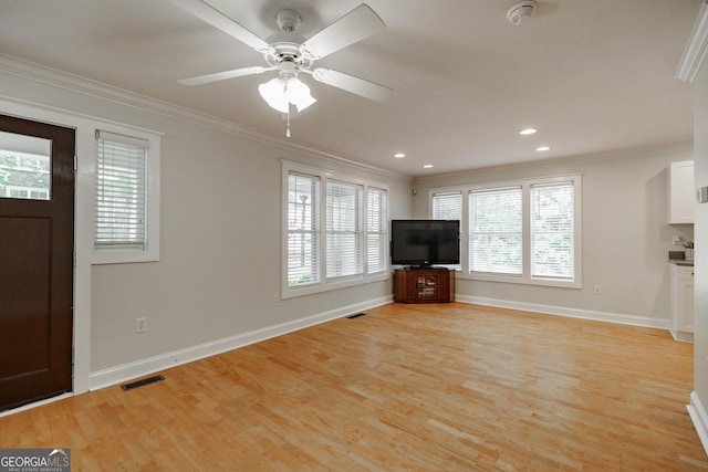 unfurnished living room with crown molding, light wood finished floors, and visible vents