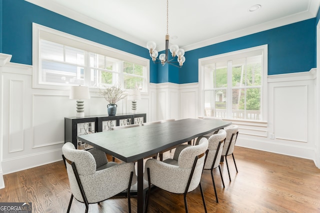 dining area with a notable chandelier, plenty of natural light, and a decorative wall