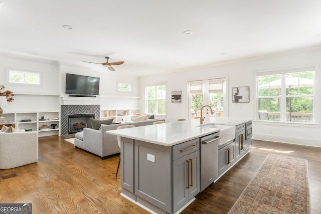 kitchen with stainless steel dishwasher, ceiling fan, gray cabinetry, and plenty of natural light