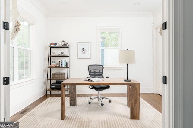 office space with baseboards, wood finished floors, and visible vents
