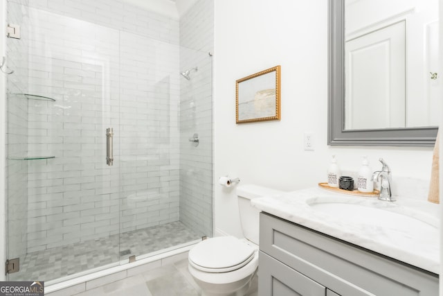 bathroom with vanity, toilet, and a stall shower