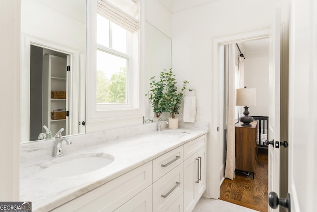 full bath with double vanity and a sink