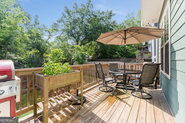 wooden deck featuring outdoor dining area and fence