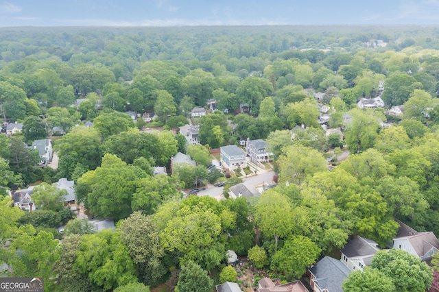 birds eye view of property featuring a residential view and a wooded view