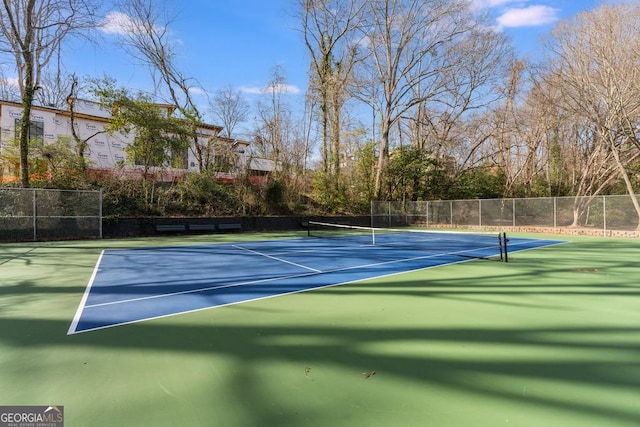 view of sport court with fence