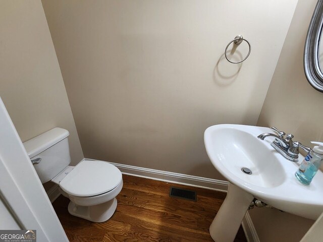 10856 Ellicot Way, Alpharetta, GA 30022 - bathroom featuring wood finished floors, toilet, baseboards, and a sink
