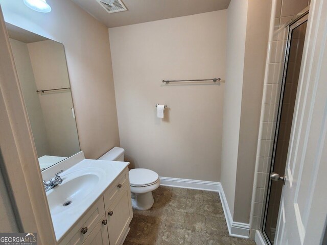 10856 Ellicot Way, Alpharetta, GA 30022 - bathroom featuring toilet, a shower with door, vanity, and baseboards