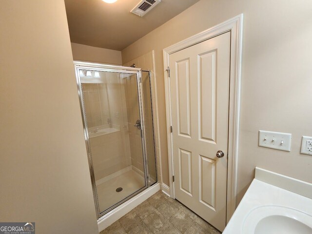 10856 Ellicot Way, Alpharetta, GA 30022 - full bath featuring a shower stall, a sink, and tile patterned floors