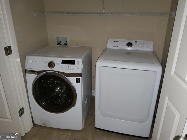 10856 Ellicot Way, Alpharetta, GA 30022 - washroom with washing machine and clothes dryer and light tile patterned floors