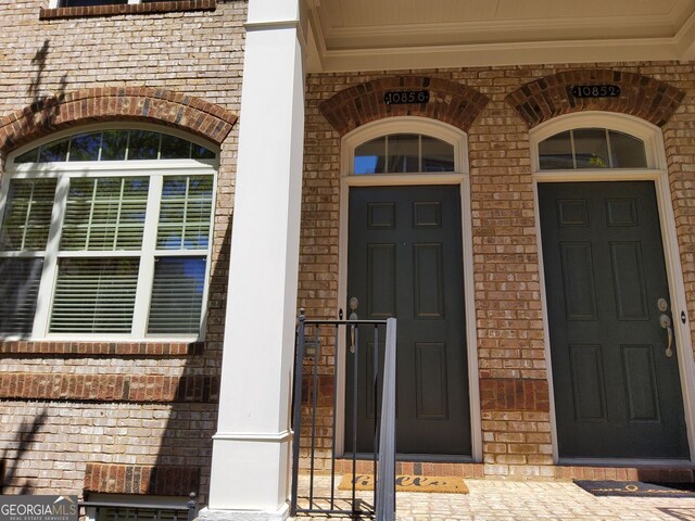 10856 Ellicot Way, Alpharetta, GA 30022 - view of exterior entry featuring brick siding and covered porch
