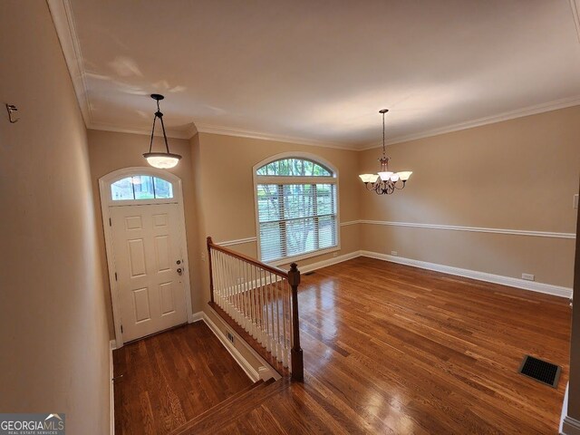 10856 Ellicot Way, Alpharetta, GA 30022 - foyer entrance with plenty of natural light, wood finished floors, baseboards, ornamental molding, and a chandelier