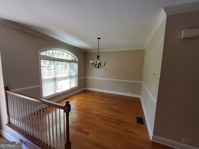 10856 Ellicot Way, Alpharetta, GA 30022 - dining space featuring a chandelier, ornamental molding, wood finished floors, and baseboards