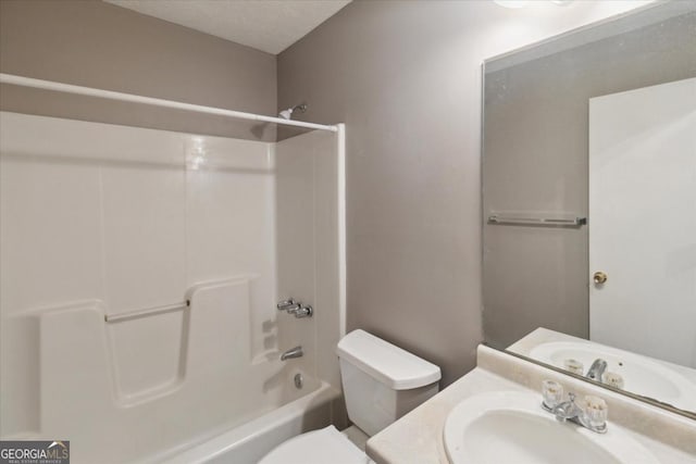 bathroom with toilet, bathing tub / shower combination, and vanity