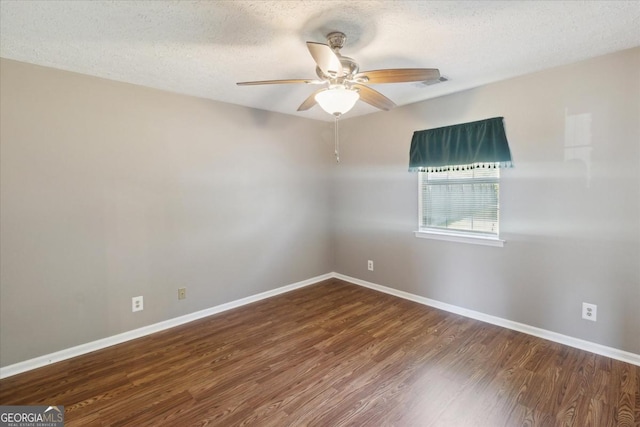 unfurnished room with ceiling fan, a textured ceiling, visible vents, wood finished floors, and baseboards