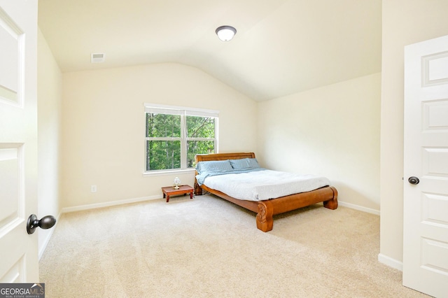 bedroom featuring visible vents, baseboards, carpet, and lofted ceiling