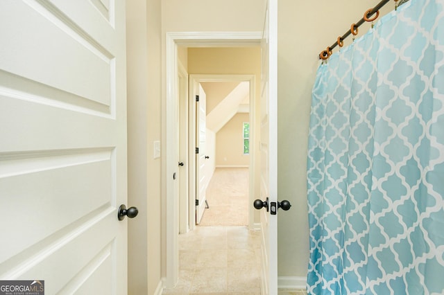 full bath with baseboards