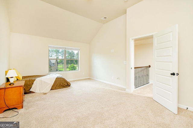 carpeted bedroom with visible vents, baseboards, and vaulted ceiling