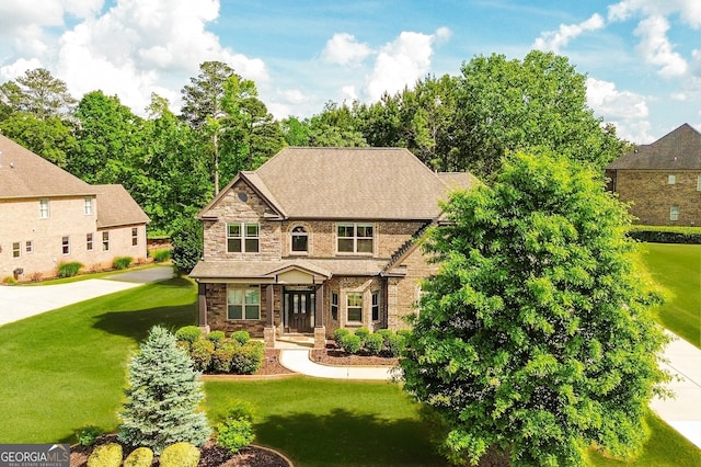 view of front of home featuring brick siding and a front lawn