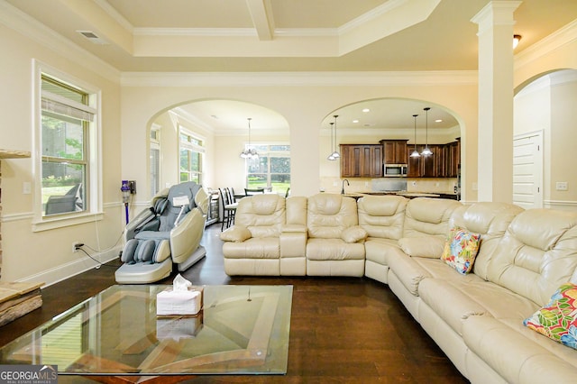 living area featuring arched walkways, ornamental molding, visible vents, and dark wood-type flooring