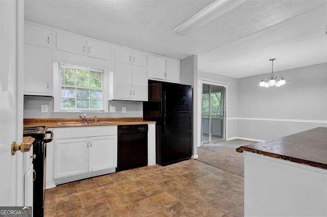3929 Emerald Springs Ct, Decatur, GA 30035 - kitchen with white cabinets, an inviting chandelier, a sink, pendant lighting, and black appliances
