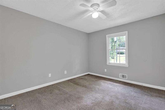 3929 Emerald Springs Ct, Decatur, GA 30035 - spare room with visible vents, baseboards, ceiling fan, and dark colored carpet
