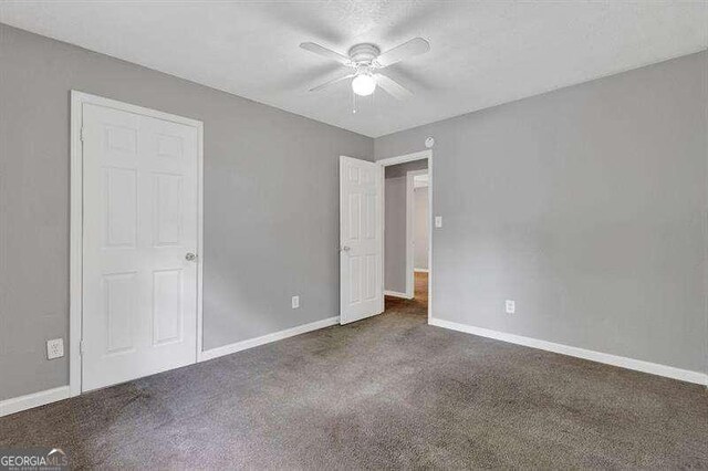 3929 Emerald Springs Ct, Decatur, GA 30035 - unfurnished bedroom featuring carpet floors, baseboards, and ceiling fan
