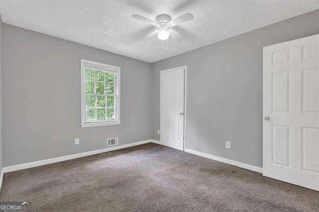 3929 Emerald Springs Ct, Decatur, GA 30035 - unfurnished bedroom featuring visible vents, carpet flooring, baseboards, and a textured ceiling
