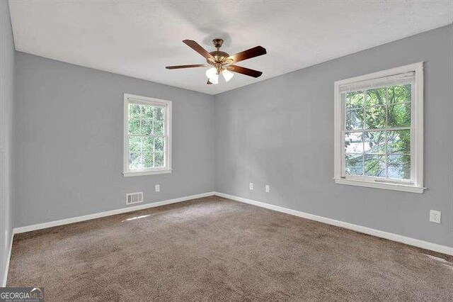 3929 Emerald Springs Ct, Decatur, GA 30035 - carpeted empty room with visible vents, a ceiling fan, and baseboards