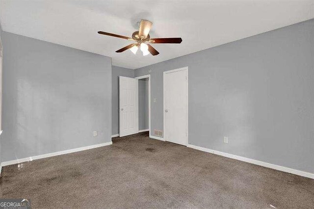 3929 Emerald Springs Ct, Decatur, GA 30035 - unfurnished bedroom featuring carpet flooring, a ceiling fan, and baseboards