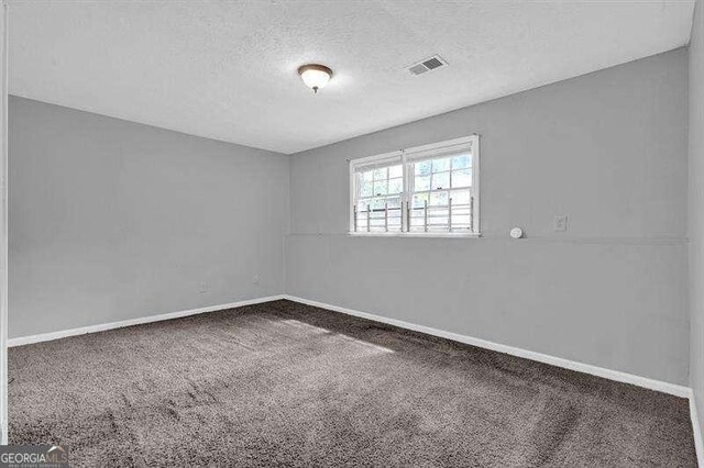 3929 Emerald Springs Ct, Decatur, GA 30035 - spare room featuring baseboards, carpet flooring, a textured ceiling, and visible vents