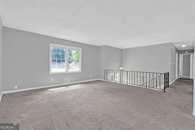 3929 Emerald Springs Ct, Decatur, GA 30035 - unfurnished room with baseboards, carpet flooring, a textured ceiling, and visible vents