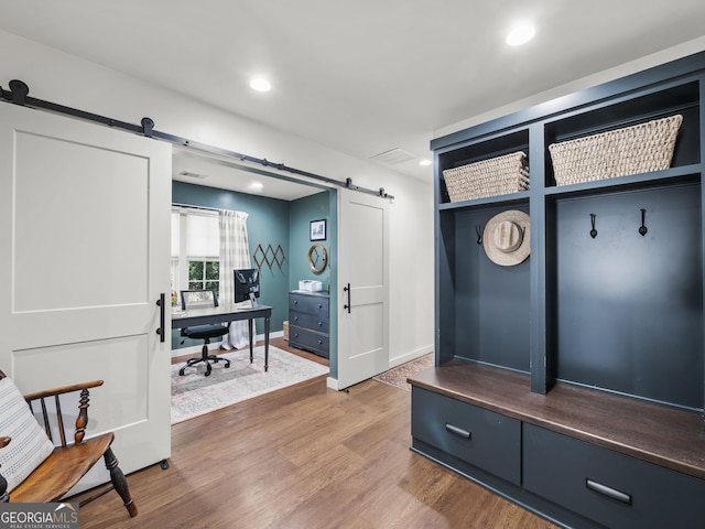 mudroom with visible vents, recessed lighting, a barn door, and wood finished floors