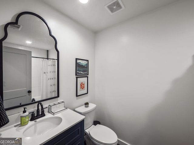 bathroom with visible vents, toilet, and vanity