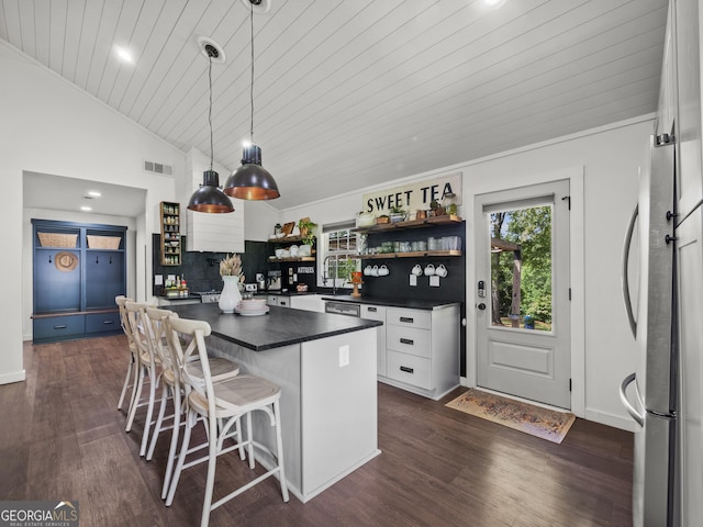 kitchen with open shelves, freestanding refrigerator, dark countertops, white cabinets, and vaulted ceiling