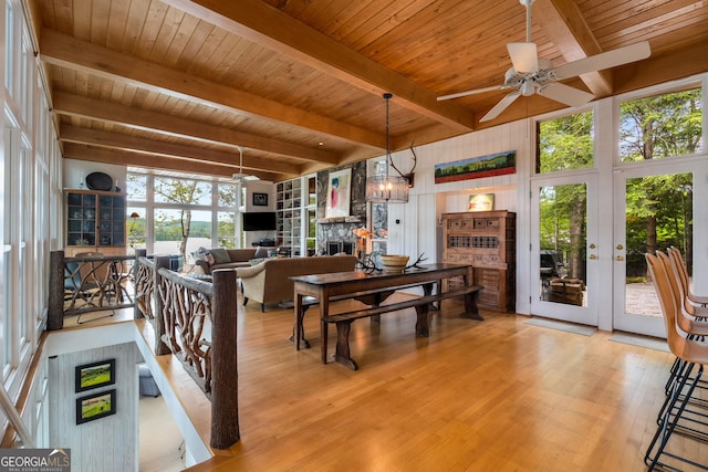 1006 Perrin Cove Rd, Tiger, GA 30576 - dining space with a ceiling fan, a stone fireplace, a wood ceiling with exposed beams, wood finished floors, and french doors