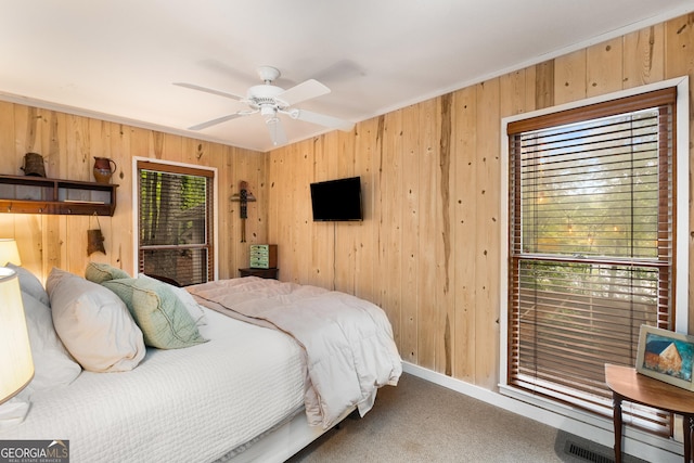 1006 Perrin Cove Rd, Tiger, GA 30576 - carpeted bedroom with wooden walls, crown molding, and ceiling fan