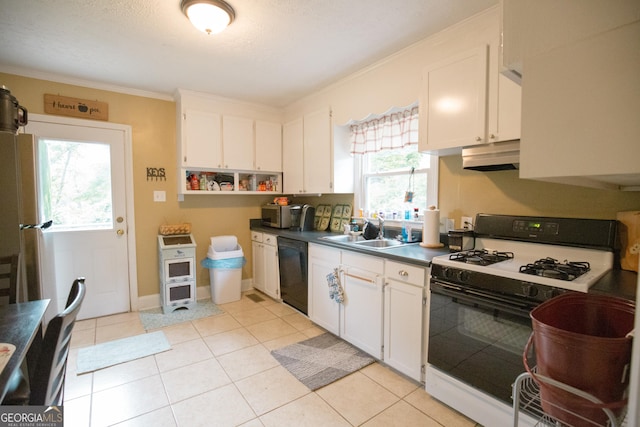 104 Upson Ave, Thomaston, GA 30286 - kitchen featuring range with gas stovetop, a healthy amount of sunlight, dark countertops, black dishwasher, and under cabinet range hood