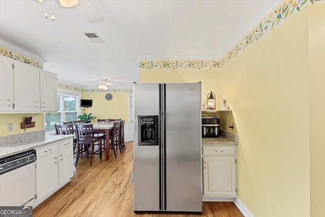 kitchen featuring a ceiling fan, white dishwasher, light wood-type flooring, stainless steel fridge, and white cabinetry