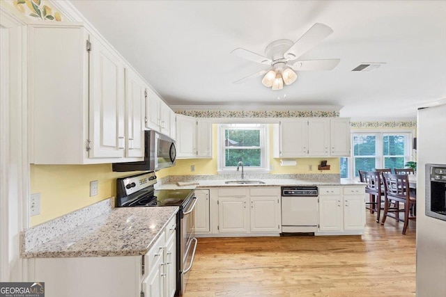 kitchen featuring appliances with stainless steel finishes, a healthy amount of sunlight, a sink, and visible vents