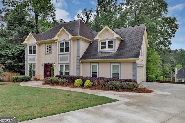 view of front facade featuring a garage, a front lawn, fence, stucco siding, and driveway