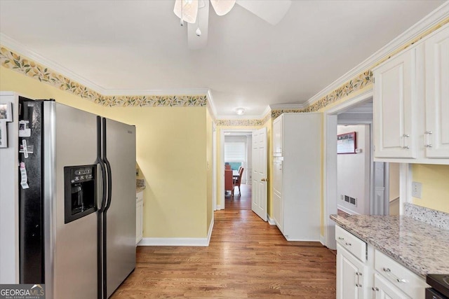 kitchen featuring white cabinets, ceiling fan, stainless steel fridge, light wood-style floors, and plenty of natural light