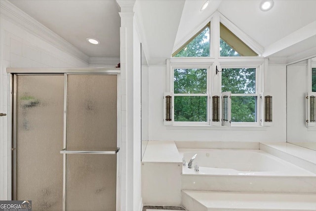full bath with lofted ceiling, plenty of natural light, a bath, and a stall shower