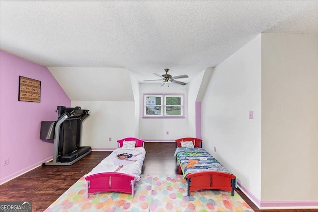 bedroom with ceiling fan, a textured ceiling, baseboards, and wood finished floors