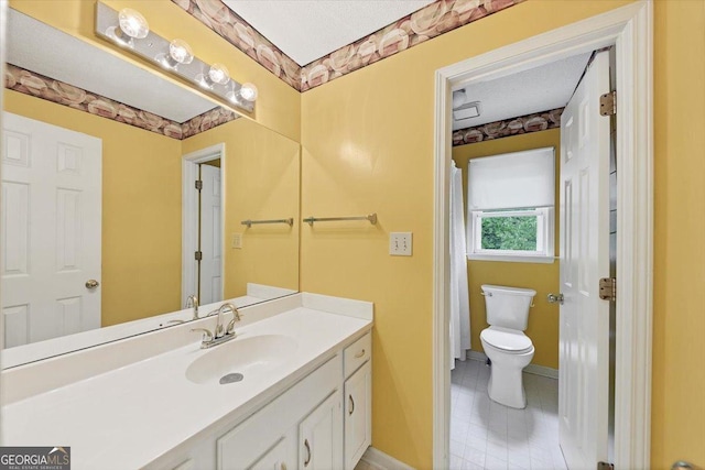 full bath featuring vanity, tile patterned floors, baseboards, and toilet