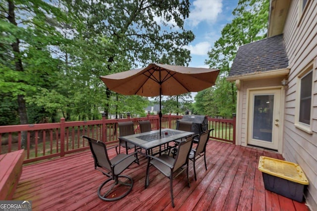 wooden deck with outdoor dining area
