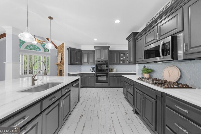 2135 Glenfield Trce, Cumming, GA 30041 - kitchen with a sink, gray cabinets, stainless steel appliances, decorative light fixtures, and backsplash