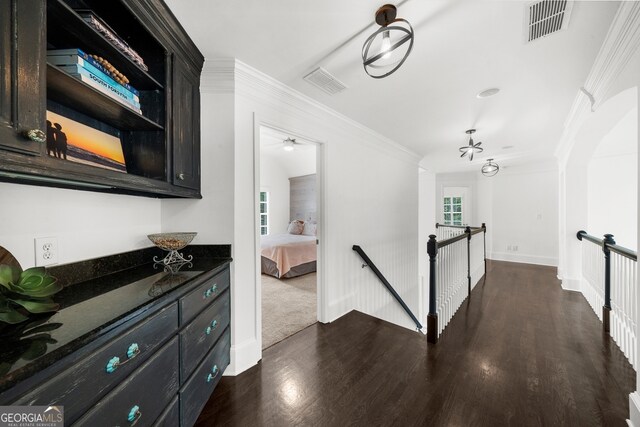 2135 Glenfield Trce, Cumming, GA 30041 - hallway with visible vents, ornamental molding, dark wood finished floors, and an upstairs landing