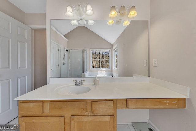 bathroom with vanity, a shower stall, and lofted ceiling